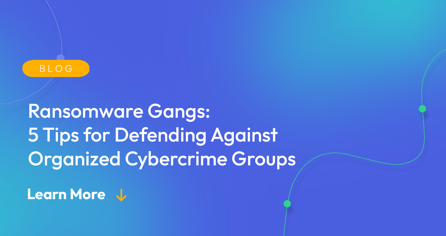 Gradient blue background. There is a light orange oval with the white text "BLOG" inside of it. Below it there's white text: "Ransomware Gangs: 5 Tips for Defending Against Organized Cybercrime Groups." There is white text underneath that which says "Learn More" with a light orange arrow pointing down.
